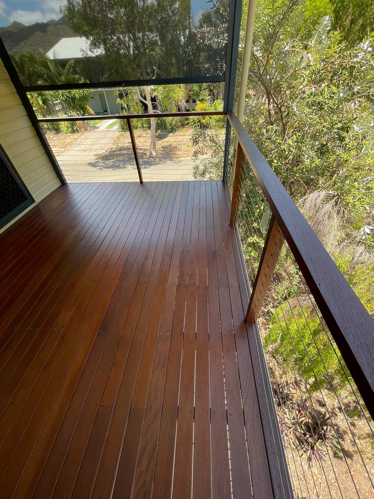 Freshly stained balcony deck with dark handrail
